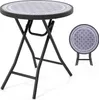 A round folding table with a patterned top and black metal legs is shown from the front. A smaller, folded version of the table is shown to the right. Podgląd zdjęcia produktu