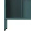 A close-up view of the bottom section of a teal metal bookshelf, showing its legs and the textured surface of the metal. Voir les images du produit