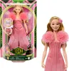 A doll in its packaging next to a separate image of the doll. Voir les images du produit