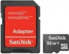 A SanDisk microSDHC adapter and a SanDisk 32GB microSDHC card are shown side-by-side on a white background. Podgląd zdjęcia produktu