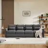 A dark gray four-seater sofa is shown in a living room setting, with a wooden slatted wall panel behind it and a bookshelf to the right. Voir les images du produit