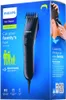 The image shows the packaging of a Philips hair clipper. The box is blue and features an illustration of the hair clipper, a family silhouette, and a person getting their hair cut. Náhled obrázku produktu