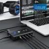 A black USB sound card is connected to a laptop, with headphones in the background. Podgląd zdjęcia produktu