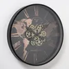 A wall clock with a world map and visible gears. Anteprima dell’immagine prodotto