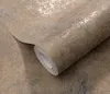 A roll of textured wallpaper with a distressed, mottled pattern in shades of brown, gray, and gold. Produktbild-Vorschau
