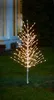 A decorative LED tree with warm white lights stands on a grassy lawn in front of a building. Produktbild-Vorschau