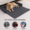A golden retriever dog is lying on a dark gray pet couch cover with raised edges, which is placed on a light gray floor. The image also includes three circular insets below the main image, demonstrating product features. Náhled obrázku produktu