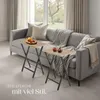 Two small folding tables are placed in front of a sofa in a living room setting. Produktbild-Vorschau