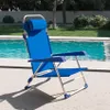 A blue folding chair is placed on a patio next to a swimming pool. Voir les images du produit