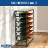 A metal wine rack filled with wine bottles, standing against a white wall with shadows. Anteprima dell’immagine prodotto