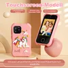 A pink toy smartphone with a unicorn design is shown next to a functional pink smartphone displaying two children. The background is a light, neutral tone. Produktbild-Vorschau