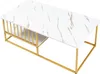 A rectangular coffee table with a white marble-look top and a gold metal frame, featuring a slatted shelf on one side. Náhľad obrázku produktu