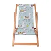 A wooden deck chair with a fabric seat featuring a pattern of llamas and cacti. Podgląd zdjęcia produktu