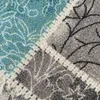 A close-up view of a carpet with a patterned design. Produktbild-Vorschau