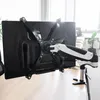 A monitor arm attached to a desk, holding a monitor. Náhled obrázku produktu