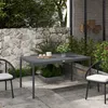 An outdoor patio setting with a dark gray rectangular table and two chairs. Produktbild-Vorschau