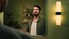 A man is looking at himself in the mirror in a bathroom. Voir les images du produit