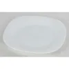 A white dessert plate on a light gray textured surface. Podgląd zdjęcia produktu