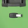 A close-up view of a green suitcase with a black luggage tag attached. Anteprima dell’immagine prodotto