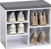 A white shoe cabinet with a gray seat cushion on top, filled with various shoes. Produktbild-Vorschau