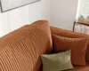 A close-up view of a corduroy sofa with two throw pillows. Produktbild-Vorschau