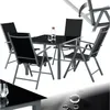 A black glass-topped dining table with four black folding chairs, set against a white background. Náhled obrázku produktu