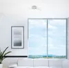 A modern living room with a large window overlooking a landscape. Produktbild-Vorschau
