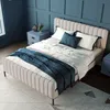 A bedroom scene with a bed, nightstands, and wall paneling.