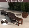A long, curved wooden bench placed on an outdoor patio with greenery in the background. Náhled obrázku produktu
