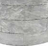 A close-up view of stacked stone blocks forming a curved structure. Produktbild-Vorschau