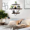A bedroom scene with a diamond-shaped wall shelf mounted above a bed. Produktbild-Vorschau