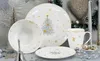A festive Christmas-themed dinnerware set is displayed on a table with decorative elements. Produktbild-Vorschau