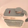 A close-up view of a De'Longhi mini fan heater. Voir les images du produit