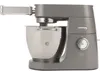 A gray Kenwood stand mixer with a stainless steel bowl and a pasta attachment. Produktbild-Vorschau
