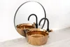 A modern bathroom sink with a gold basin and black faucet, reflected in a circular mirror. Produktbild-Vorschau