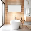 A modern bathroom with a freestanding bathtub, wooden wall paneling, and a sleek white infrared heater mounted on the wall. Náhľad obrázku produktu