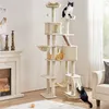 A tall, multi-level cat tree with several cats interacting with it, placed in a living room setting next to a fireplace. Podgląd zdjęcia produktu
