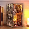 A miniature 3D model of a castle-like structure, designed to fit between books on a shelf, with intricate details and interior lighting. Voir les images du produit