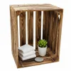 A wooden crate with folded towels, a potted plant, and a stone. Anteprima dell’immagine prodotto