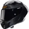 A black carbon fiber motorcycle helmet with a tinted visor, shown from a three-quarter front angle against a white background. Anteprima dell’immagine prodotto