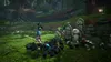 A character in a blue jacket stands in a forest clearing, surrounded by small black creatures and ancient stone statues. Produktbild-Vorschau