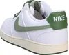 A close-up side view of a white Nike sneaker with green accents. Produktbild-Vorschau