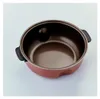 A top-down view of an empty red multi-cooker pot with black handles against a light gray background. Anteprima dell’immagine prodotto