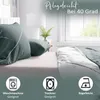 A bed with green and white striped bedding, set in a bedroom with a window in the background. Produktbild-Vorschau