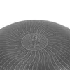 Close-up view of the textured bottom of a pan, showing a circular emblem with symbols and text. Náhled obrázku produktu