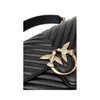 A close-up of a black quilted handbag with gold bird embellishments. Voir les images du produit
