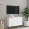 A white TV cabinet mounted on a gray wall, with a TV on top and a plant to the side. Produktbild-Vorschau