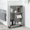 A narrow, rolling storage cart filled with various bathroom products and towels, placed next to a sink. Náhľad obrázku produktu