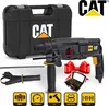 A Caterpillar rotary hammer drill kit with accessories, presented with promotional elements like a red bow and a box of drill bits. Náhled obrázku produktu