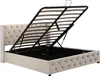 A beige upholstered bed frame with the mattress support mechanism lifted to reveal the storage compartment underneath. Podgląd zdjęcia produktu